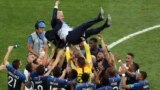 French players throw their head coach Didier Deschamps into the air to celebrate at the end of the final match between France and Croatia at the 2018 soccer World Cup in the Luzhniki Stadium in Moscow, Russia. France won its second World Cup title by beating Croatia 4-2.