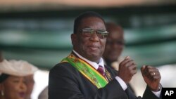 FILE - Zimbabwe President Emmerson Mnangagwa gestures during his inauguration ceremony at the National Sports Stadium in the capital, Harare, Sept. 4 2023. 