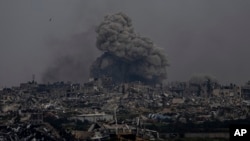 Smoke and explosions rise inside the Gaza Strip, as seen from southern Israel, March 17, 2024