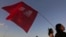 A supporter of Brazil's former President Luiz Inacio Lula da Silva carries a flag with text written in Portuguese that reads "Free Lula" during a protest in front of the headquarters of the Brazilian Supreme Court, in Brasilia, Brazil, July 9, 2018. 