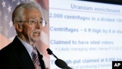 A woman kneels as she appeals to Ukrainian police troops at the site of clashes with anti-government protesters in Kyiv. Protesters erected more street barricades and occupied a government ministry building on Friday after the failure of crisis talks. 