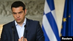 PM Yunani Alexis Tsipras dalam konferensi pers di Athena, Rabu (17/6). Yunani terancam mengalami kegagalan bayar utang (default). 