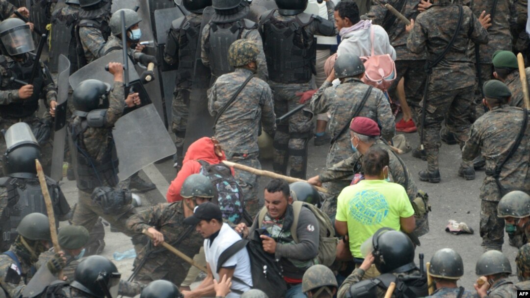 Honduran migrants, part of a caravan heading to the United States, clash with Guatemalan security forces in Vado Hondo, Guatemala, Jan. 17, 2021. 