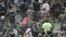 Honduran migrants, part of a caravan heading to the United States, clash with Guatemalan security forces in Vado Hondo, Guatemala, Jan. 17, 2021. 
