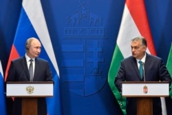 Hungarian Prime Minister Viktor Orban, right, and Russian President Vladimir Putin hold a joint press conference in the Castle of Buda in Budapest, Hungary, Oct. 30, 2019.