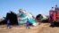 Members of Burma's Fire Brigade team gather near a damaged Air Bagan passenger plane in Heho, Shan State, Dec. 25, 2012.