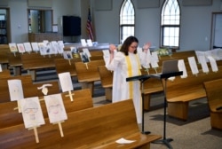 FILE - A pastor leads a virtual Sunday service online during the coronavirus pandemic, at Peace Lutheran church, in Burlington, North Dakota, April 26, 2020.