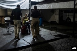 National Migration Institute agents detain a Venezuelan migrant at a checkpoint in Nuevo Teapa, southern Mexico, June 8, 2024. Mexico is under pressure from the U.S. to block millions of migrants headed north.