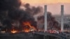 Anti-government demonstrators block a bridge with debris and burning tires in the southern Iraqi city of Nasiriyah.