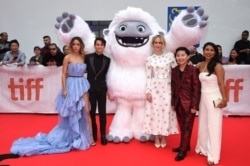 FILE - From left, actors Chloe Bennet, Tenzing Norgay Trainor, Sarah Paulson, Albert Tsai and Michelle Wong pose with the character Everest from "Abominable" during the film's premiere at the Toronto International Film Festival, Sept. 7, 2019.