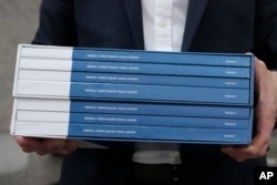 Copies of the Grenfell Tower Inquiry report are photographed after it was released in London, Sept. 4, 2024.