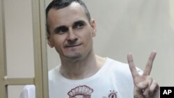 Ukrainian filmmaker Oleh Sentsov gestures as the verdict is delivered at his trial in Rostov-on-Don, Russia, Aug. 25, 2015.