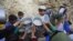 Afghan villagers flock around free food donated by other villagers as they prepare to break their fast during the holy month of Ramadan in Kabul.