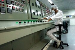 FILE - A technician works at the Uranium Conversion Facility just outside the city of Isfahan, Iran, 255 miles (410 kilometers) south of the capital Tehran, Feb. 3, 2007.