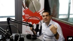 Greece's Prime Minister Alexis Tsipras gives an interview to the radio station ''Sto Kokkino 1055'' in Athens, July 29, 2015.