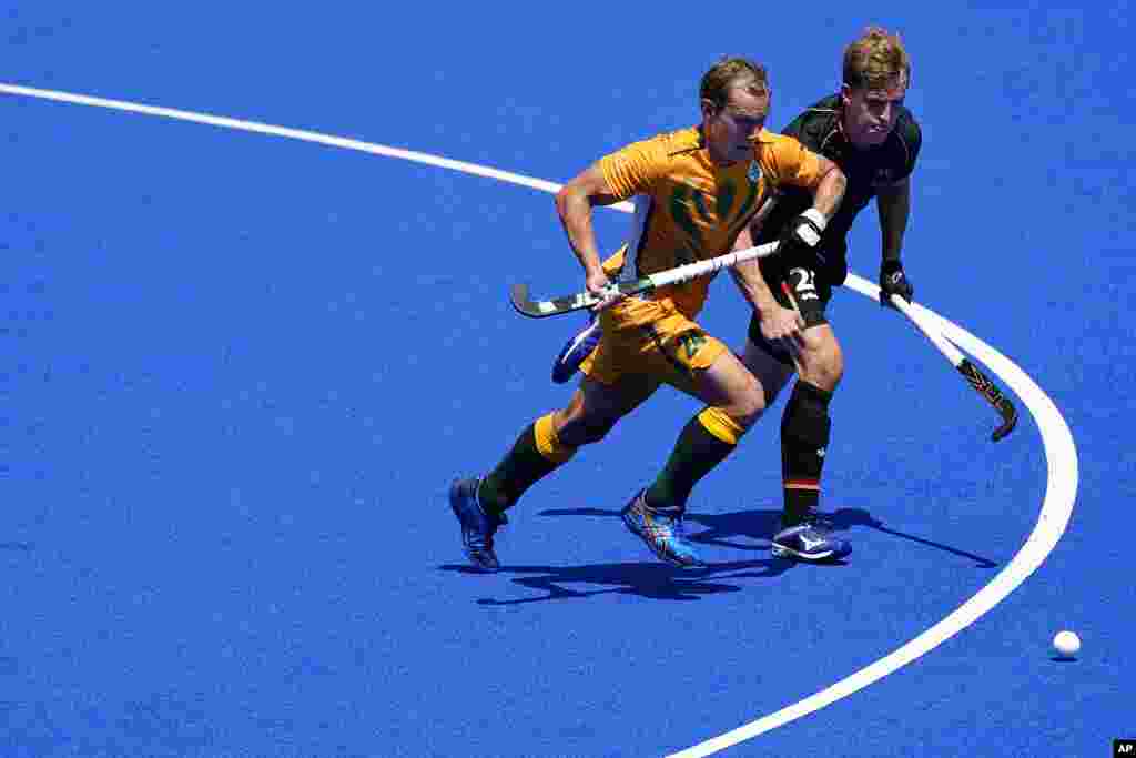 South Africa&#39;s Nicholas Balfour Spooner (24) and Germany&#39;s Niklas Bosserhoff (26) chase the ball during a men&#39;s field hockey match at the 2020 Summer Olympics, Thursday, July 29, 2021, in Tokyo, Japan. (AP Photo/John Minchillo)