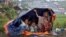 Rohingya refugees shelter from the rain in a camp in Cox's Bazar, Bangladesh, Sept. 17, 2017.