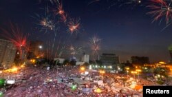Fireworks burst over opponents of Egypt's Islamist President Mohamed Morsi, in Tahrir Square in Cairo, Egypt, July 2, 2013.