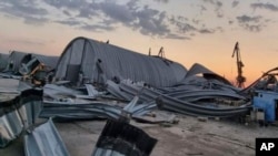 In this photo provided by the Odesa Regional Administration Press Office, a granary destroyed in a Russian drone attack at night is seen in a Danube port near Odesa, Ukraine, early hours Aug. 16, 2023.