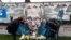 People view a mural of late record-breaking centenarian Captain Tom Moore, who died on Tuesday, in Two Gates, Tamworth, Britain, Feb. 3, 2021.