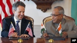 Treasury Secretary Timothy Geithner, left, and Indian Finance Minister Pranab Mukherjee smile after signing a joint statement on the U.S.-India Economic and Financial Partnership, Tuesday, June 28, 2011