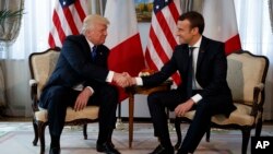 President Donald Trump shakes hands with French President Emmanuel Macron during a meeting at the U.S. Embassy, May 25, 2017, in Brussels.