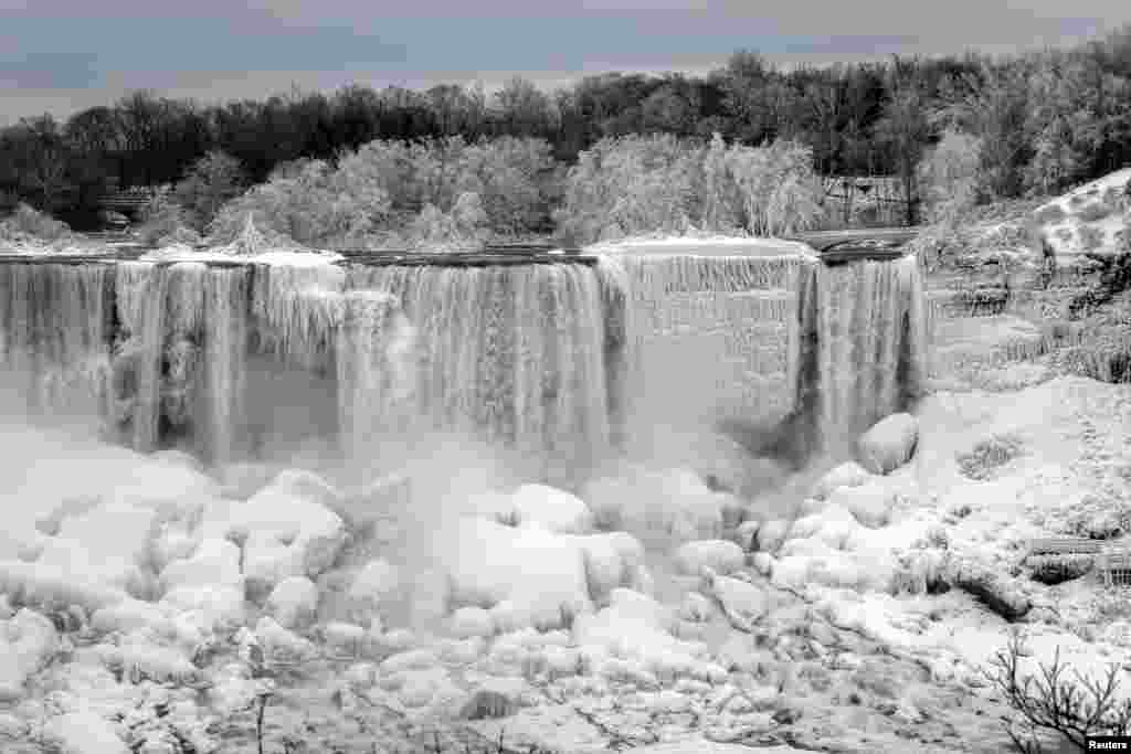 The U.S. side of Niagara Falls in Niagara Falls, New York, is frozen due to subzero temperatures, viewed from the Canadian side, Ontario, Jan. 22, 2019.