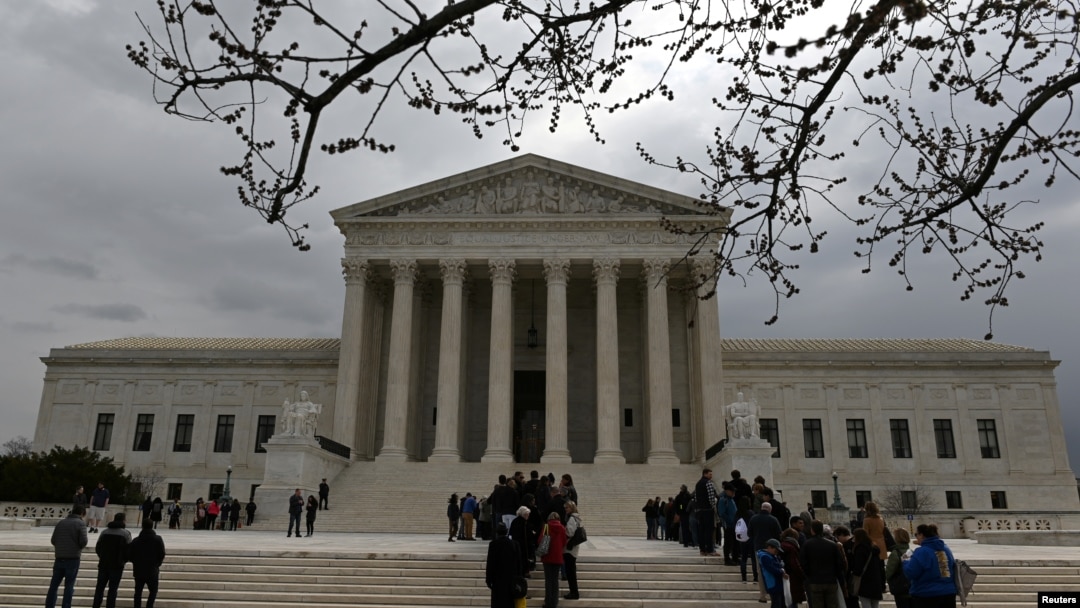 People wait in line outside the U.S. Supreme Court to hear the orders being issued, in Washington, March 18, 2019. 