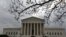 FILE - People wait in line outside the U.S. Supreme Court to hear the orders being issued, in Washington, March 18, 2019. 