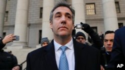 Michael Cohen walks out of federal court in New York, Nov. 29, 2018, after pleading guilty to lying to Congress about work he did on an aborted project to build a Trump Tower in Russia. Cohen told the judge he lied about the timing of the negotiations.