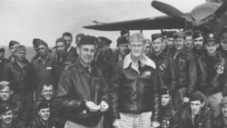 Lt. Col. Jimmy Doolittle accepts a medal from the skipper of the USS Hornet, Capt. Marc A. Mitscher.