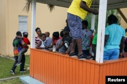 Hurricane Dorian refugees, many of them from Great Abaco, pass the time at a shelter set up at the Kendal G.L. Isaacs National Gymnasium in Nassau, New Providence, Bahamas, Sept. 10, 2019.