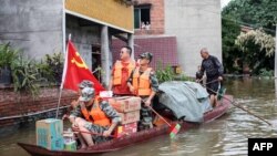 Pekerja komunitas dan sukarelawan mengirimkan bantuan makanan dan kebutuhan pokok untuk penduduk yang terdampak banjir di Neijiang, provinsi Sichuan, barat daya China, 19 Agustus 2020. 