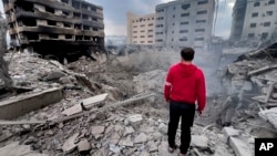 A man looks at buildings destroyed by Israeli airstrikes in Dahiyeh, Beirut, Lebanon, on Oct. 7, 2024.