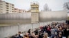 People attend a flower-laying ceremony on the 35th anniversary of the felling of the Berlin Wall at the Berlin Wall Memorial 0n Nov. 9, 2024.