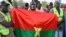 FILE—Supporters of the Alliance Of Sahel States (AES) hold up a Burkina Faso Flag as they celebrate Mali, Burkina Faso and Niger leaving the Economic Community of West African States (ECOWAS) in Niamey on January 28, 2024.