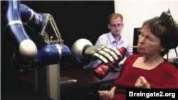 Cathy Hutchinson drinking from a bottle using the robotic arm