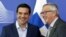 Greek Prime Minister Alexis Tsipras (L) is welcomed by European Commission President Jean-Claude Juncker ahead of a meeting at the EU Commission headquarters in Brussels, June 3, 2015. 