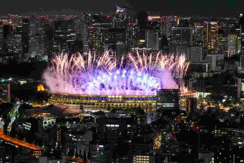 Fireworks illuminate over National Stadium during the opening ceremony of 2020 Tokyo Olympics, July 23, 2021, in Tokyo.