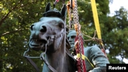 A statue of Confederate General Thomas 'Stonewall' Jackson is removed after years of a legal battle over the contentious monument, in Charlottesville, Virginia, July 10, 2021. 