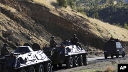 Turkish soldiers in armored vehicles patrol in Sirnak province on the Turkish-Iraqi border, October 21, 2011.