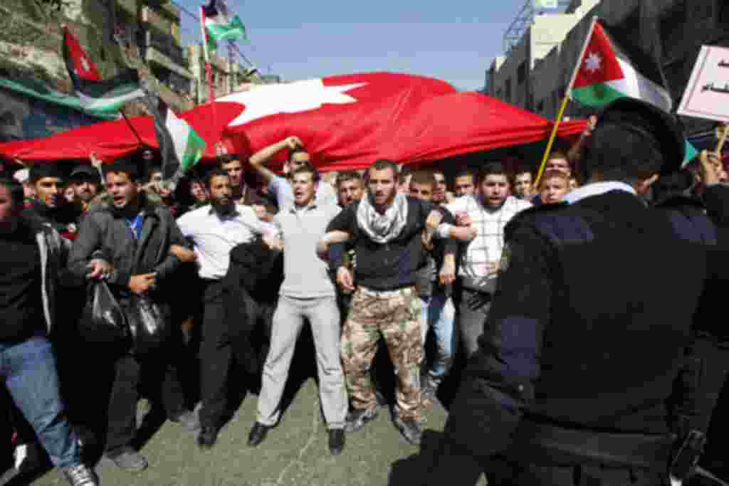 Anti-government protesters shout slogans during a demonstration after Friday prayers in Amman, Jordan, March 04, 2011