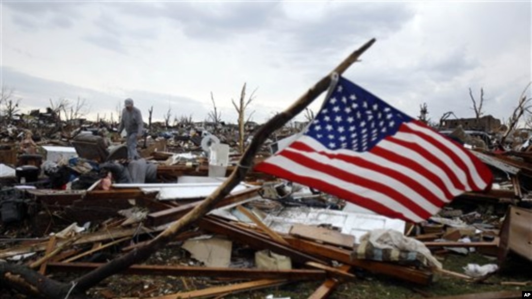Josh Ramsey looks through the rubble of what is left of his mother-in-law's home following a tornado Monday, May 23, 2011, in Joplin , Mo.