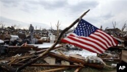 Josh Ramsey looks through the rubble of what is left of his mother-in-law's home following a tornado Monday, May 23, 2011, in Joplin , Mo.