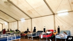 COVID-19 patients are seen at Queen Elizabeth Central Hospital COVID-19 make shift ward at Queen Elizabeth Central Hospital COVID-19 Blantyre, Malawi on Saturday, Jan. 30, 2021. Malawi faces a resurgence of COVID-19 that is overwhelming the southern…