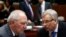 Germany's Finance Minister Wolfgang Schaeuble listens to his Lithuanian counterpart Rimantas Sadzius (R) during a European Union finance ministers meeting in Brussels, Dec. 10, 2013.