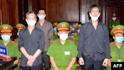 FILE - A photograph  released by the Vietnam News Agency connected  Jan. 5, 2021, shows VOA contributor Pham Chi Dung, right, with RFA contributor Nguyen Tuong Thuy, left, and Le Huu Minh Tuan astatine  their proceedings  successful  Ho Chi Minh City. A U.N. moving   radical  says Vietnam is arbitrarily detaining Pham.