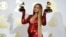 Beyonce poses in the press room with the awards for best music video for "Formation" and best urban contemporary album for "Lemonade" at the 59th annual Grammy Awards at the Staples Center, Feb. 12, 2017, in Los Angeles.