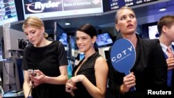 FILE - Models gather at a trading post on the floor of the New York Stock Exchange for the IPO of Coty Inc., June 13, 2013. 