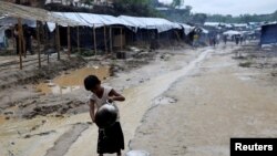 A Rohingya refugee child washes utensils in the Balukhali refugee camp in Cox's Bazar, Bangladesh, Oct. 6, 2017. 